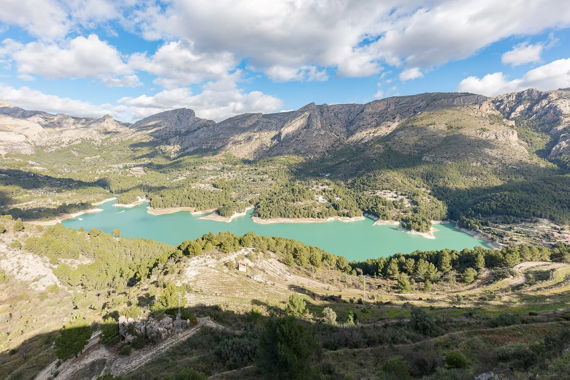 Embalse de Guadalest con aguas turquesas rodeado de montañas en un día soleado